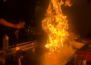 Hibachi grill with rising flames.
